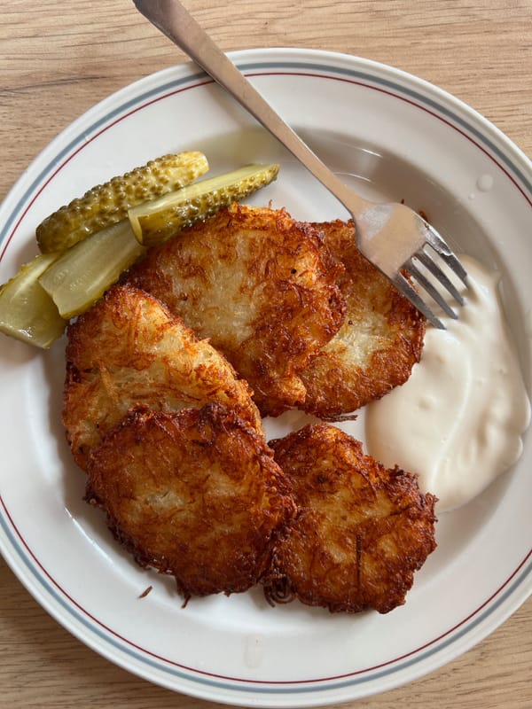 Crispy one-ingredient Russian potato pancakes (Draniki) served hot with sour cream.