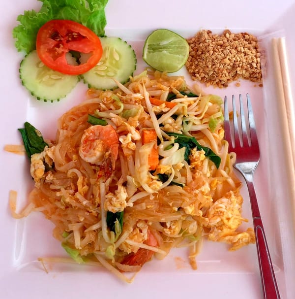 Low calorie Pad Thai Stir-Fry with rice noodles, tofu, peanuts, and fresh toppings served in a bowl.